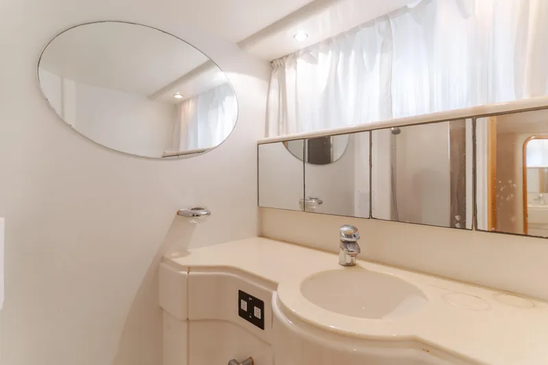 Slide: The Image of Bathroom interior of 1997 Viking Sport Cruisers 66 Motor Yacht with oval mirror and sink. - 19