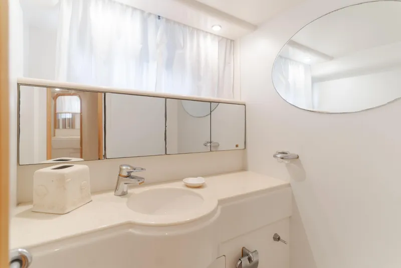 Slide: The Image of Bathroom interior of 1997 Viking Sport Cruisers 66 Motor Yacht, featuring mirrors and sink. - 21