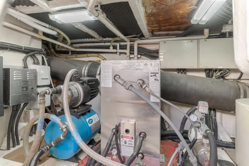 Slide: The Image of Engine room of 1997 Viking Sport Cruisers 66 Motor Yacht with mechanical equipment and piping. - 24