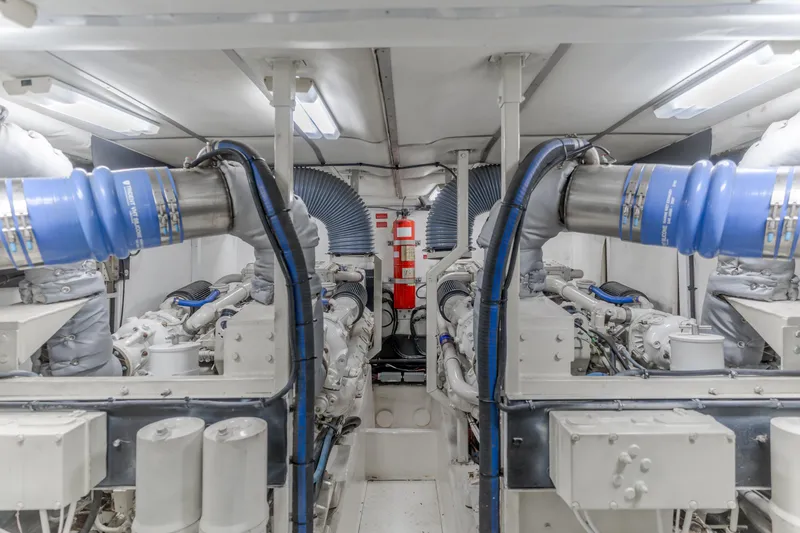 Slide: The Image of Engine room of 1997 Viking Sport Cruisers 66 Motor Yacht, featuring dual engines and exhaust systems. - 26