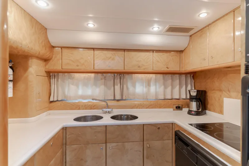 Slide: The Image of Luxurious kitchen interior of 1997 Viking Sport Cruisers 66 Motor Yacht with modern amenities. - 6