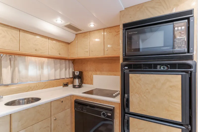 Slide: The Image of Luxurious kitchen interior of 1997 Viking Sport Cruisers 66 Motor Yacht with modern appliances. - 7