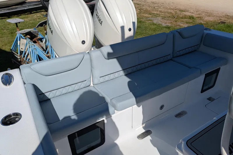 Slide: The Image of 2026 Sportsman Heritage 261 Center Console boat with cushioned seating and dual Yamaha engines. - 11