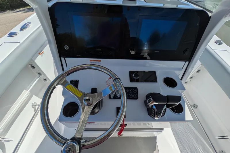 Slide: The Image of 2026 Sportsman Heritage 261 Center Console helm with steering wheel and dual screens. - 15
