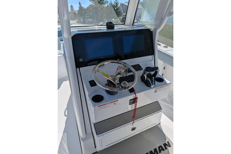 Slide: The Image of 2026 Sportsman Heritage 261 Center Console helm with steering wheel and dual screens. - 16