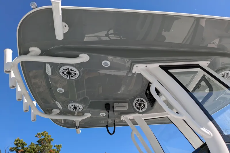 Slide: The Image of 2026 Sportsman Heritage 261 Center Console boat roof with speakers and rod holders. - 2