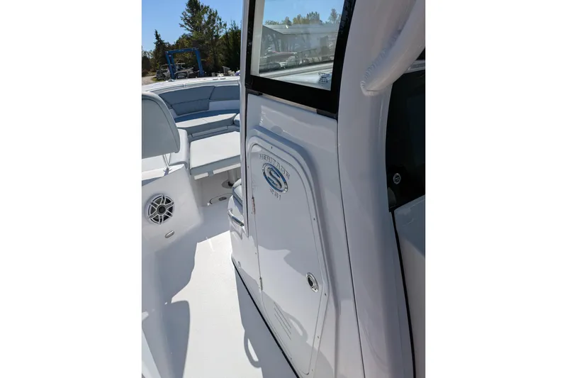 Slide: The Image of 2026 Sportsman Heritage 261 Center Console boat interior with seating and storage. - 22
