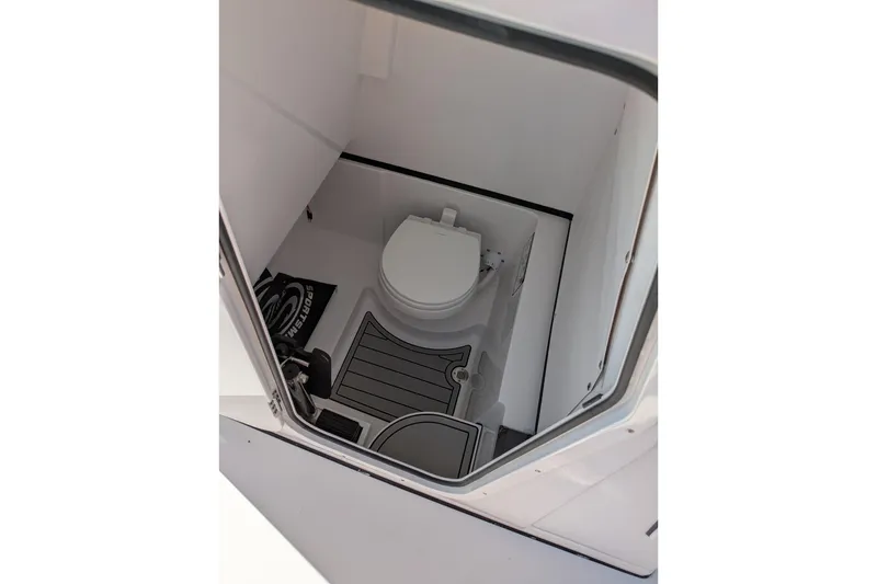 Slide: The Image of Interior view of 2026 Sportsman Heritage 261 Center Console boat's compact bathroom. - 23