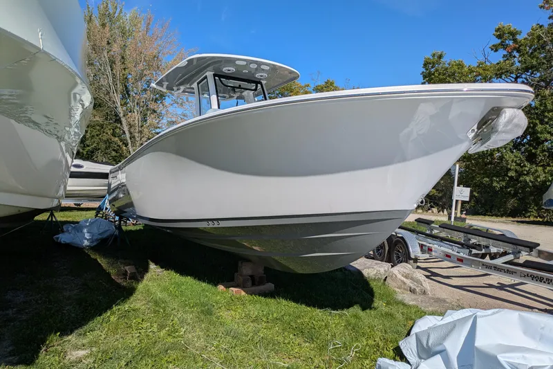 Slide: The Image of 2026 Sportsman Heritage 261 Center Console boat on display outdoors. - 3