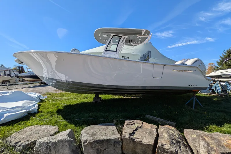 Slide: The Image of 2026 Sportsman Heritage 261 Center Console boat on display outdoors. - 4