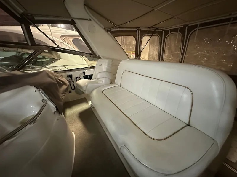 Slide: The Image of Interior of a 1997 Sea Ray Sundancer 400 yacht with white leather seating. - 12