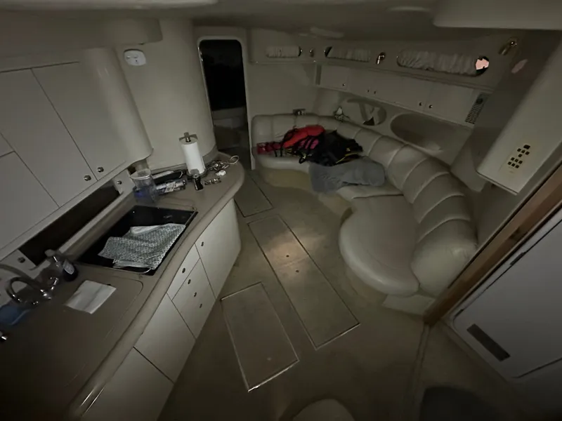 Slide: The Image of Interior of a 1997 Sea Ray Sundancer 400 yacht with kitchen and seating area. - 8