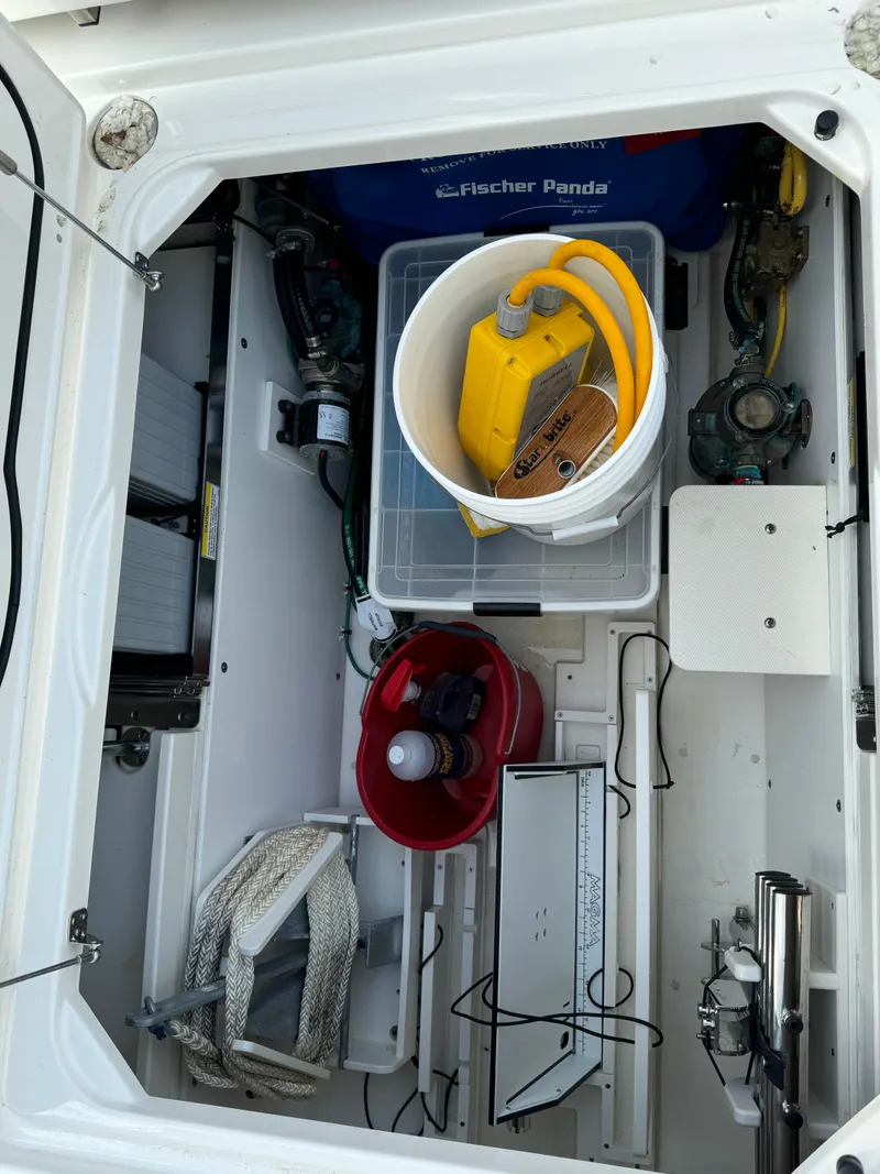 Slide: The Image of Storage compartment of a 2021 Pursuit DC 365 boat with various equipment. - 10