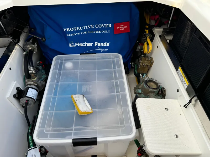Slide: The Image of Engine compartment of a 2021 Pursuit DC 365 boat with Fischer Panda protective cover. - 11