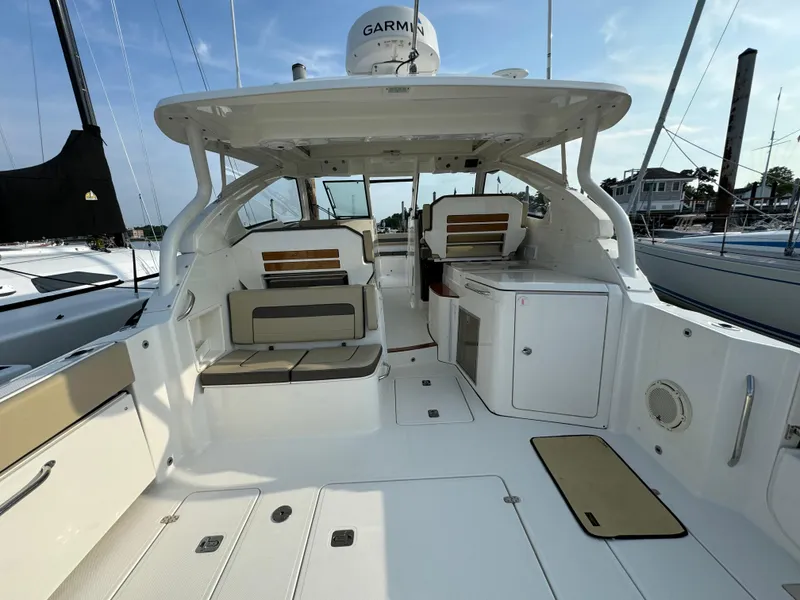 Slide: The Image of 2021 Pursuit DC 365 boat interior with seating and storage compartments. - 5