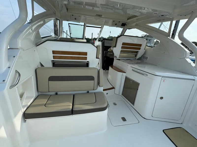 Slide: The Image of Interior of a 2021 Pursuit DC 365 boat with seating and storage areas. - 8