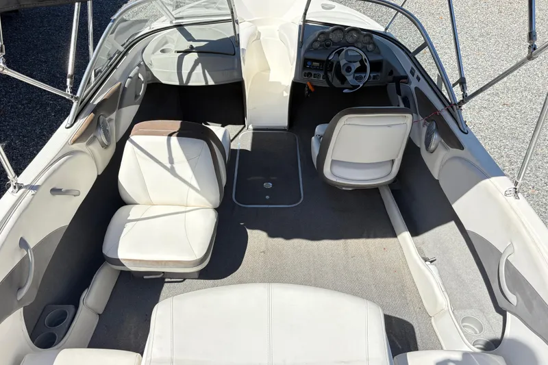 Slide: The Image of 2009 Bayliner 185 Bowrider interior with seating and steering wheel, showcasing spacious design. - 11