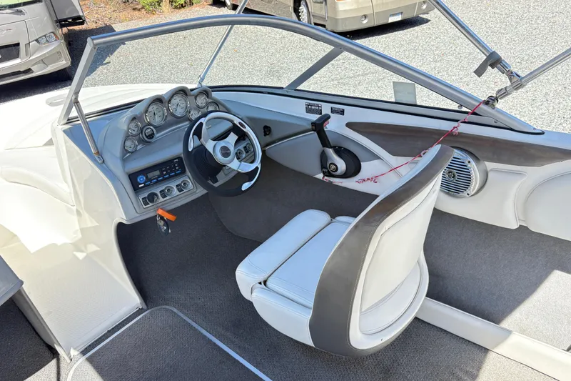 Slide: The Image of 2009 Bayliner 185 Bowrider interior with steering wheel, dashboard, and seating. - 4
