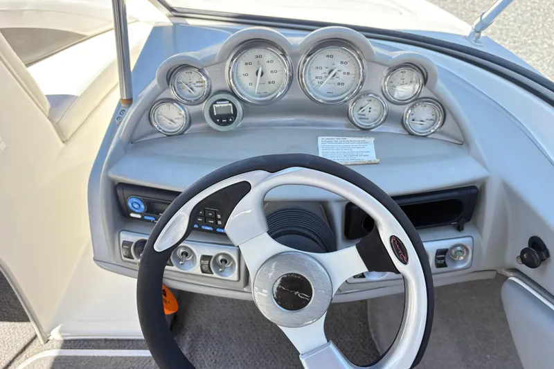 Slide: The Image of Dashboard of a 2009 Bayliner 185 Bowrider boat with steering wheel and gauges. - 5