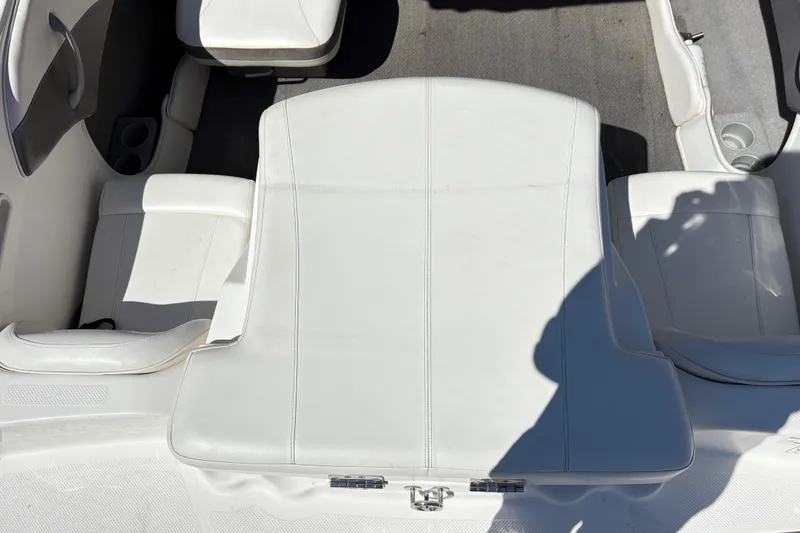 Slide: The Image of 2009 Bayliner 185 Bowrider interior with white seating and cup holders. - 6