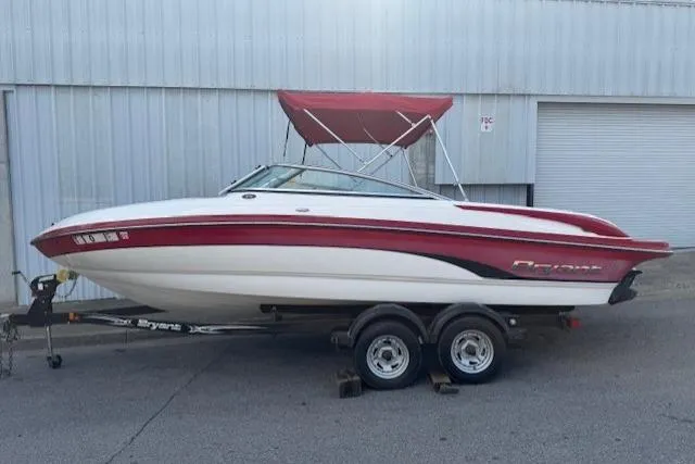 Slide: The Image of 2011 Bryant 210 boat with red and white design on a trailer. - 1