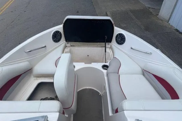 Slide: The Image of 2011 Bryant 210 boat interior with white seating and red accents. - 11
