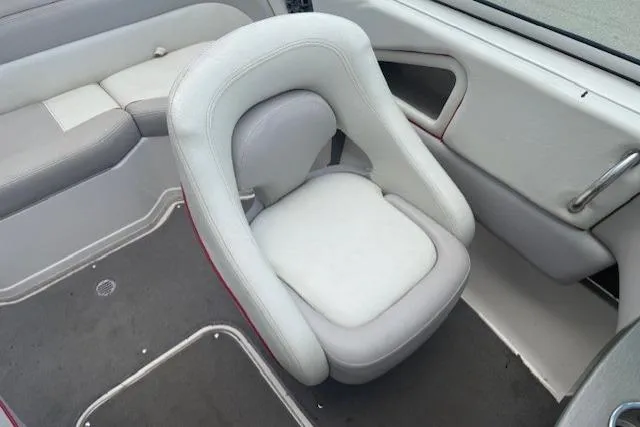Slide: The Image of Interior of a 2011 Bryant 210 boat featuring white and gray seating. - 13