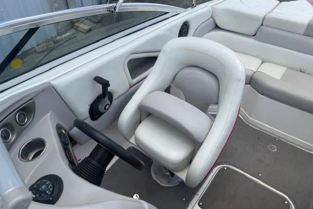 Slide: The Image of Interior of a 2011 Bryant 210 boat featuring steering wheel and seating. - 17