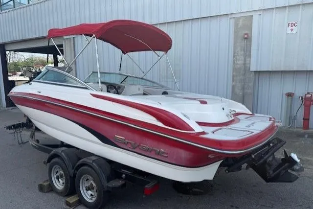 Slide: The Image of Red and white 2011 Bryant 210 boat with canopy on a trailer. - 2