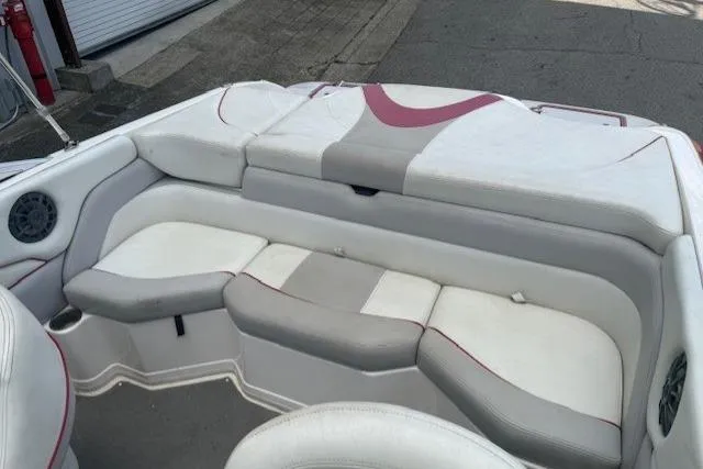 Slide: The Image of 2011 Bryant 210 boat interior with white and gray seating. - 22