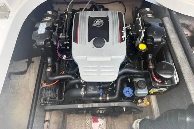 Slide: The Image of Engine compartment of a 2011 Bryant 210 boat, featuring a 4.3L MerCruiser engine. - 24
