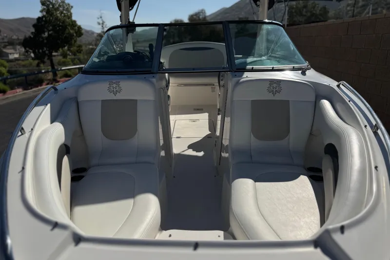 Slide: The Image of 2011 Chaparral 267 SSX boat interior with white seating and windshield. - 13