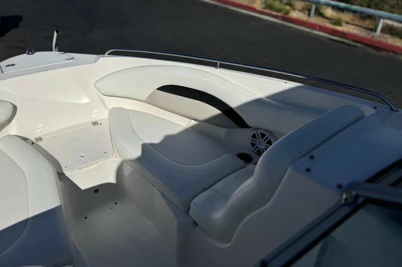 Slide: The Image of 2011 Chaparral 267 SSX boat interior with white seating and speaker detail. - 16