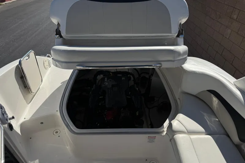 Slide: The Image of 2011 Chaparral 267 SSX boat engine compartment with open seating area. - 22