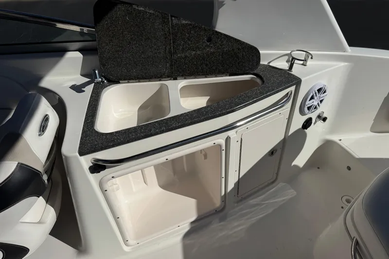 Slide: The Image of 2011 Chaparral 267 SSX boat interior with sink, storage, and speaker. - 24