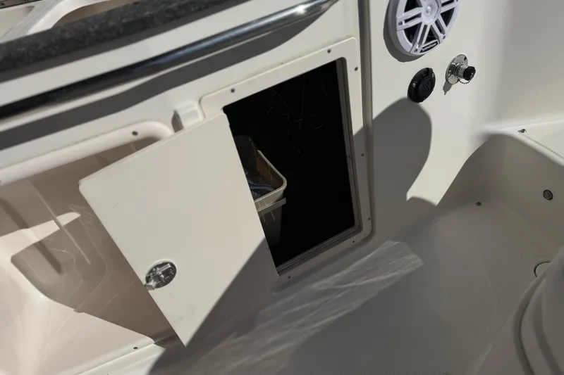 Slide: The Image of Open storage compartment on 2011 Chaparral 267 SSX boat interior. - 25