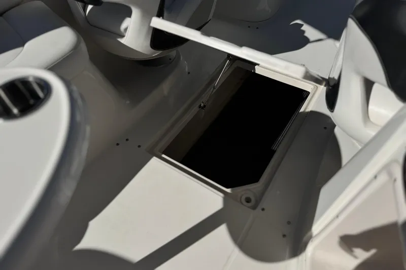 Slide: The Image of Open storage compartment on 2011 Chaparral 267 SSX boat interior. - 28