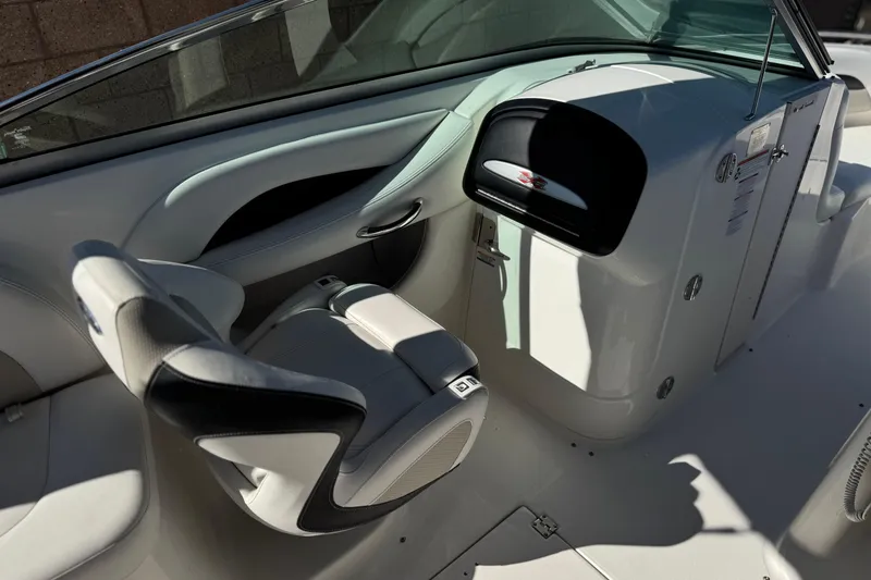 Slide: The Image of Interior of a 2011 Chaparral 267 SSX boat, featuring sleek seating and dashboard. - 29