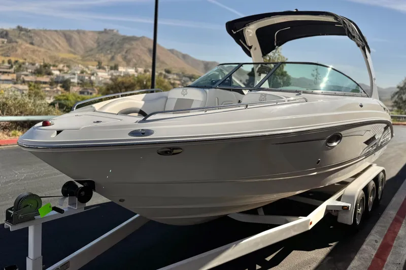 Slide: The Image of 2011 Chaparral 267 SSX boat on trailer, scenic mountain background. - 3