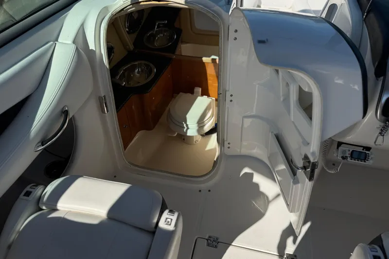 Slide: The Image of Interior view of 2011 Chaparral 267 SSX boat featuring a compact bathroom. - 30
