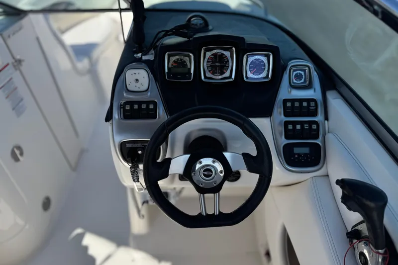 Slide: The Image of Cockpit view of 2011 Chaparral 267 SSX boat with steering wheel and dashboard controls. - 33