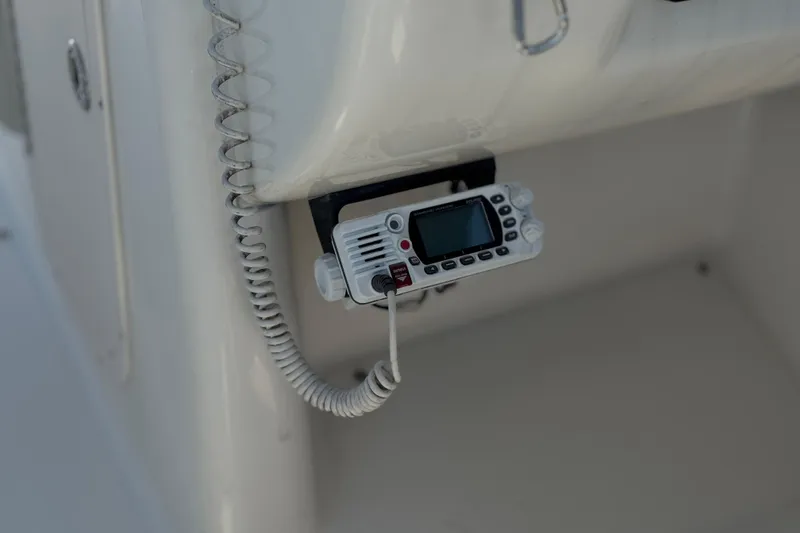 Slide: The Image of VHF radio installed on a 2011 Chaparral 267 SSX boat dashboard. - 35