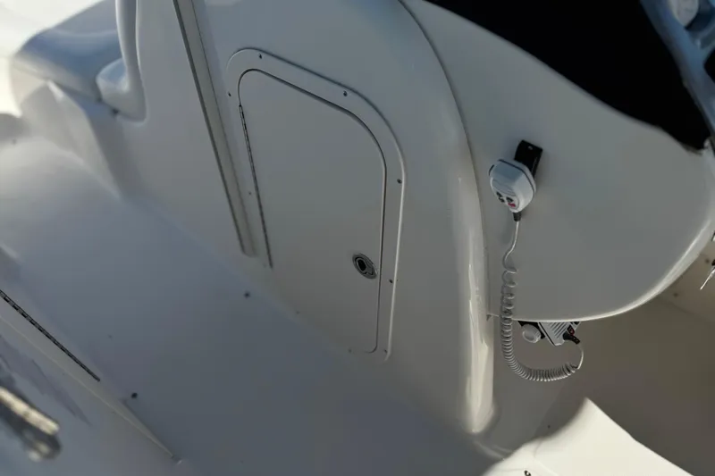 Slide: The Image of 2011 Chaparral 267 SSX boat interior with control panel and storage compartment. - 36