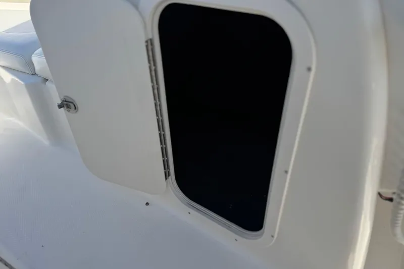 Slide: The Image of Open storage compartment on 2011 Chaparral 267 SSX boat, white interior. - 37