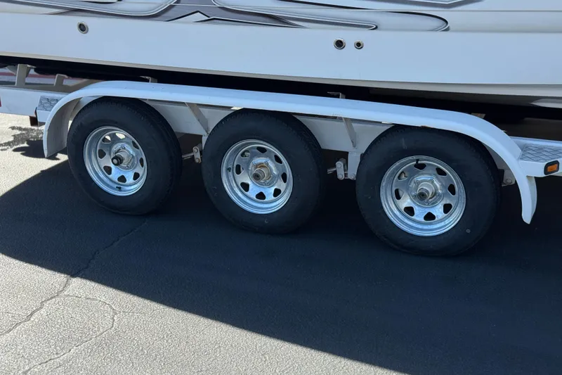 Slide: The Image of Triple-axle trailer for 2011 Chaparral 267 SSX boat on pavement. - 38