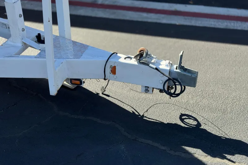 Slide: The Image of Trailer hitch of a 2011 Chaparral 267 SSX boat on asphalt pavement. - 39