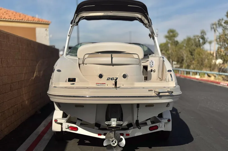 Slide: The Image of 2011 Chaparral 267 SSX boat on trailer, rear view, parked outdoors. - 4