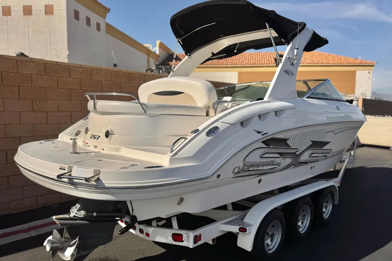 Slide: The Image of 2011 Chaparral 267 SSX boat on trailer, parked outdoors, showcasing sleek design. - 5
