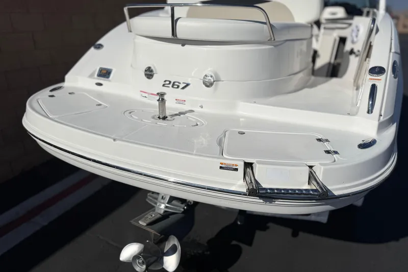 Slide: The Image of 2011 Chaparral 267 SSX boat rear view with swim platform and ladder. - 7