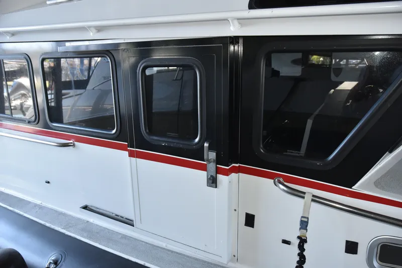 Slide: The Image of 2005 SAFE Boats 33 Full Cabin exterior with sliding door and windows. - 12